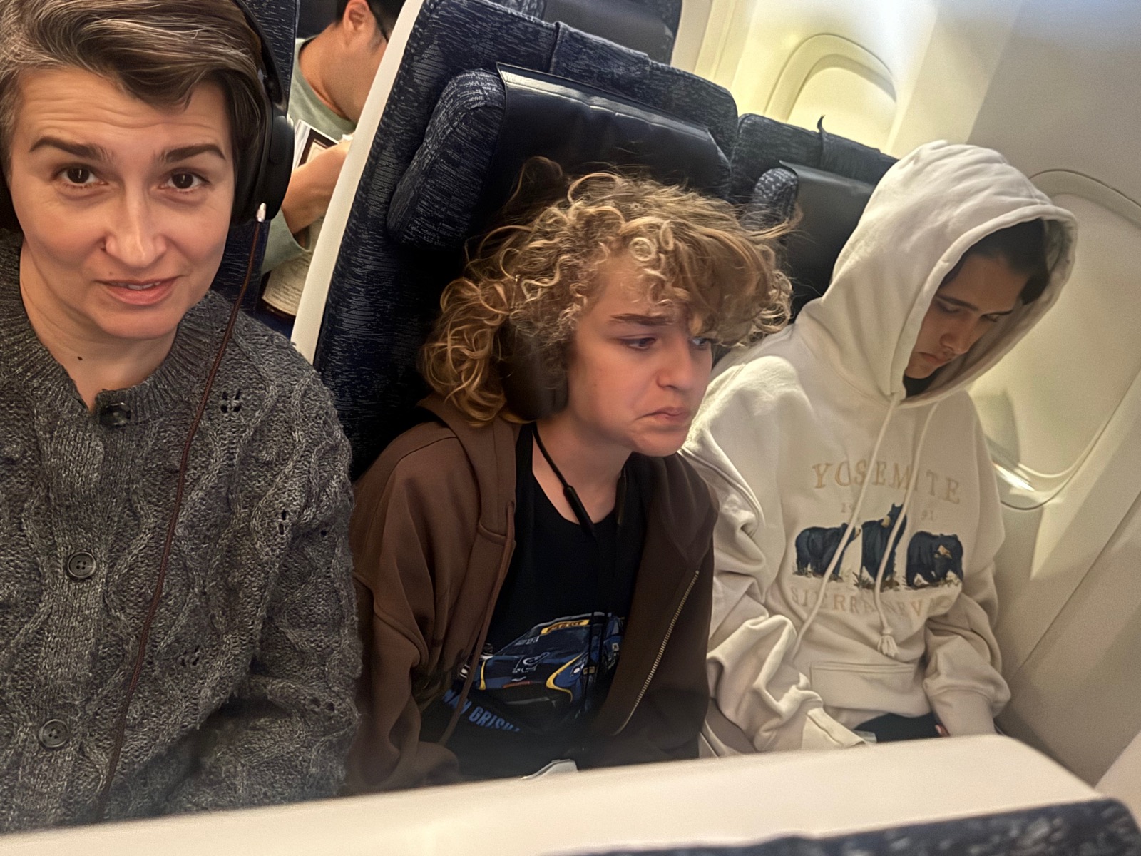 Natalia, Luca, and Seraphima on the ANA flight to Tokyo