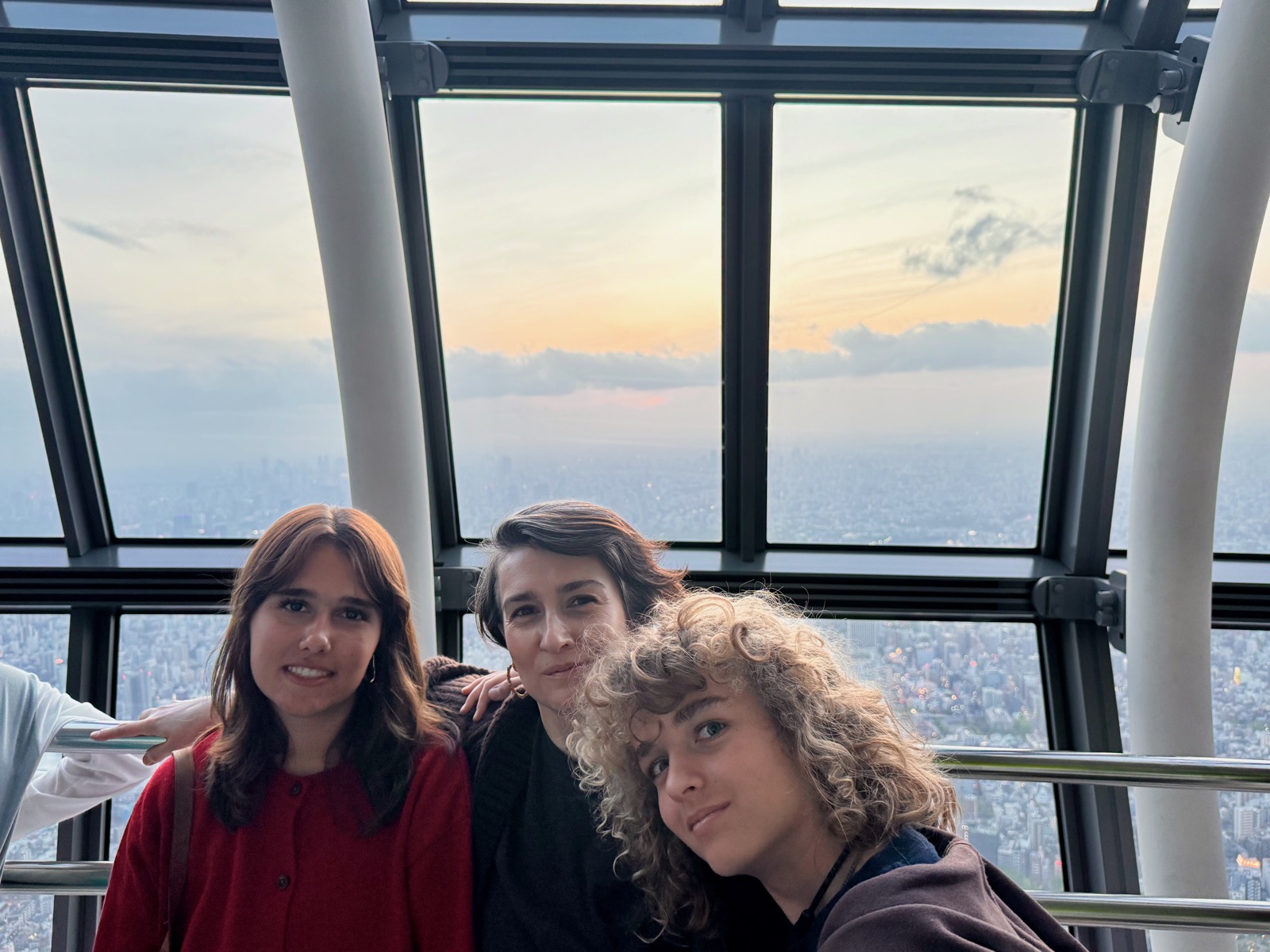 Seraphima, Natalia, and Luca selfie at Skytree Tembo Galleria with sunset