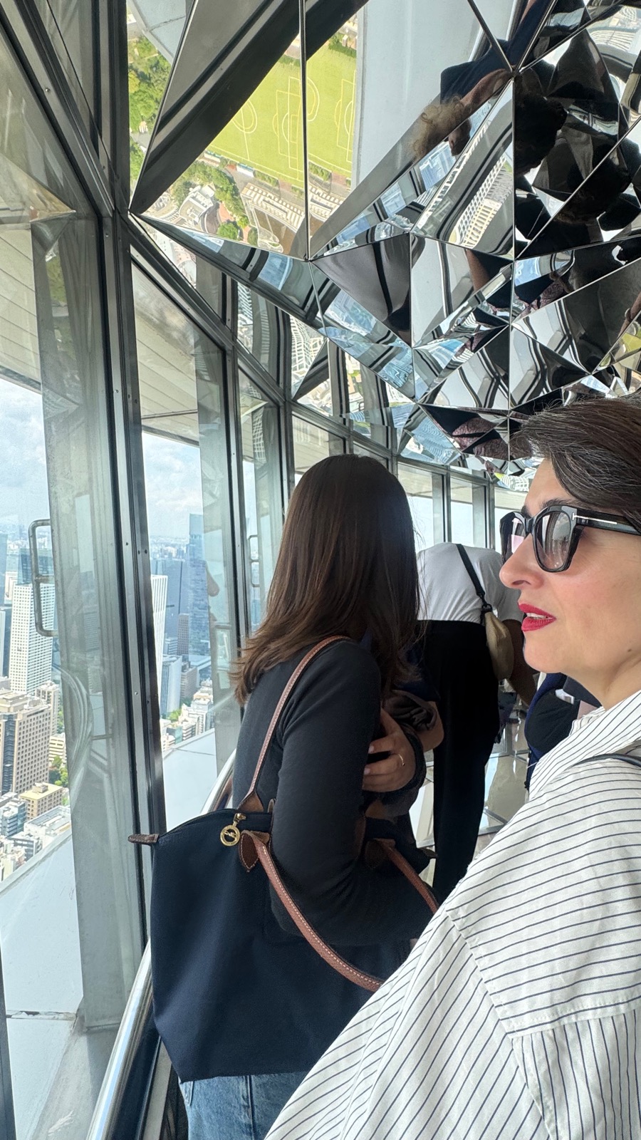 Natalia at the Tokyo Tower Main Deck mirrored viewing area with city views below