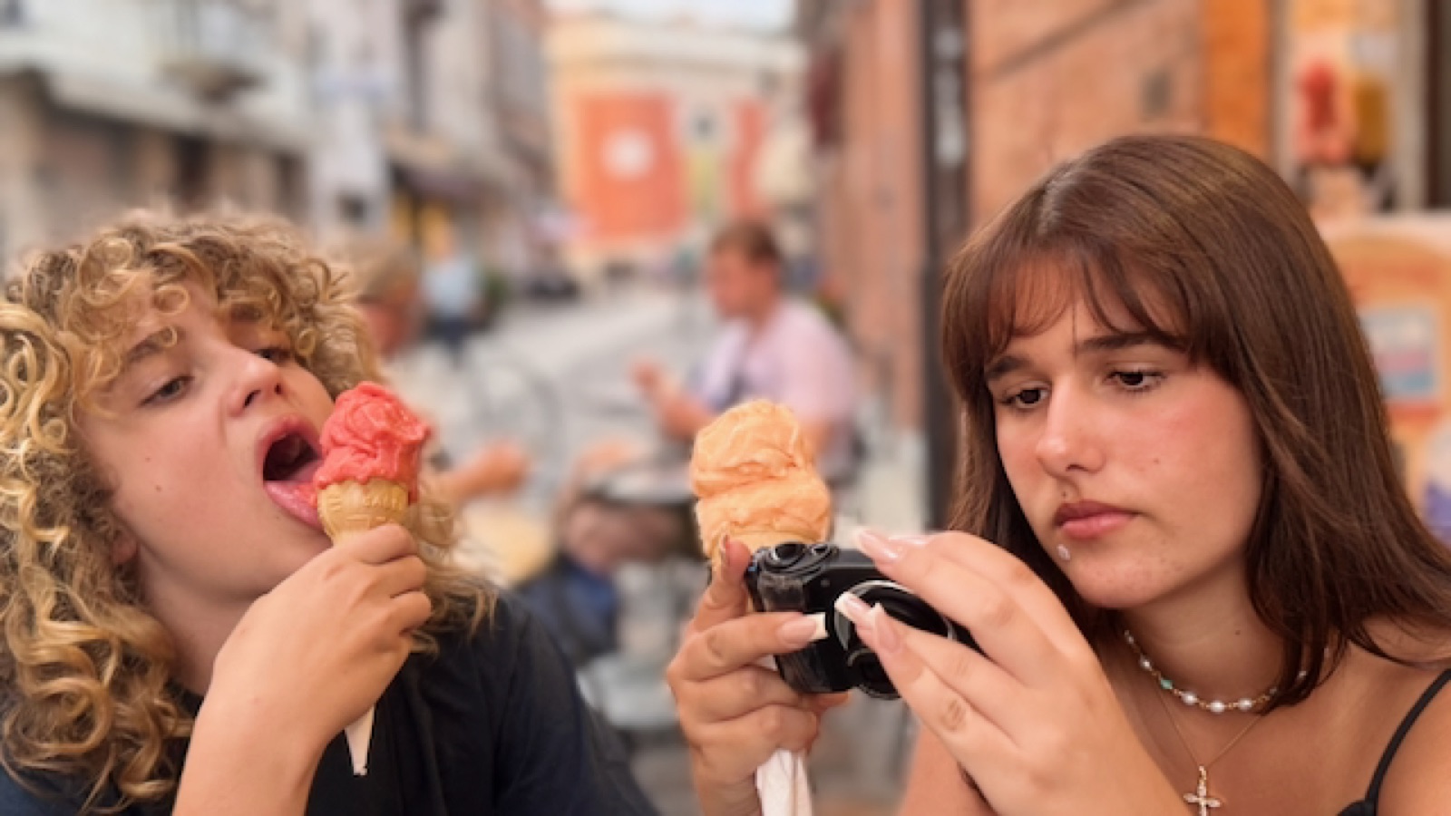Gelato hour — Luca mid-lick, Phima checking her camera